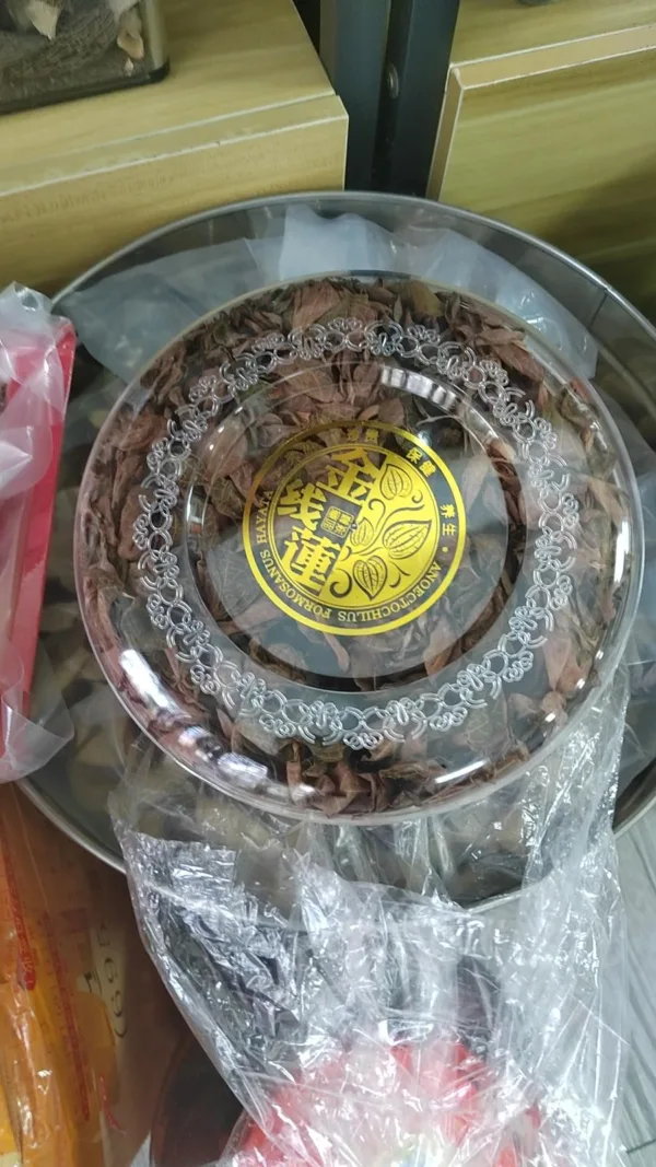 Packaged Pu'erh tea cake with label and protective wrapping.