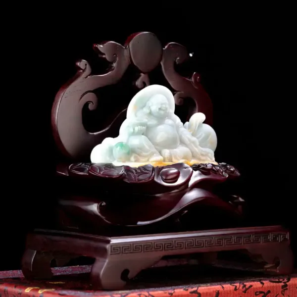 Jade Buddha statue on carved wooden stand.