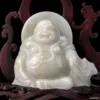 Carved white jade laughing Buddha statue.