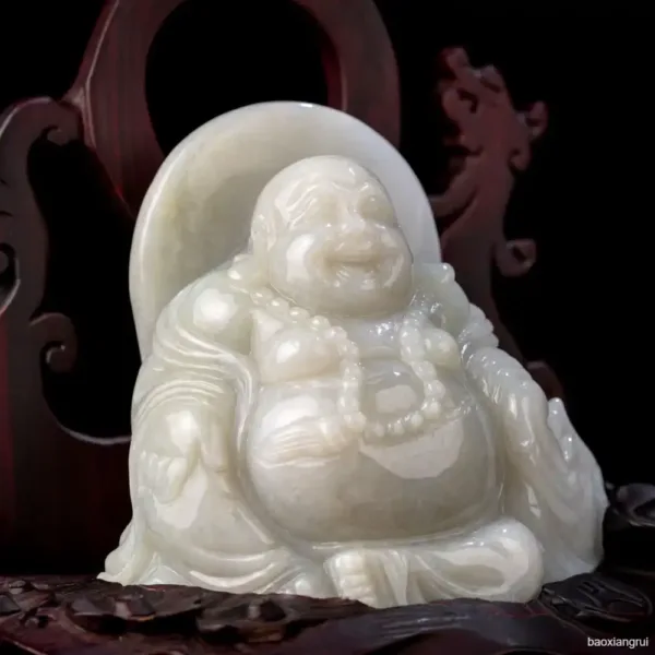 Carved white jade laughing Buddha statue.