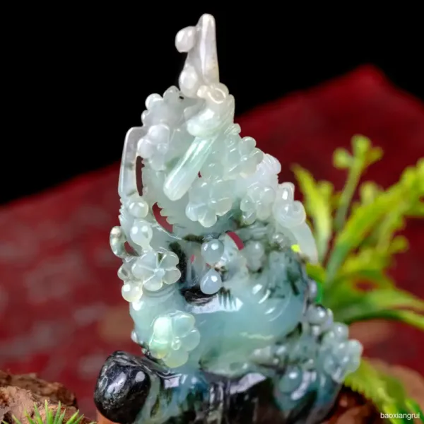 Carved jade sculpture on red background.