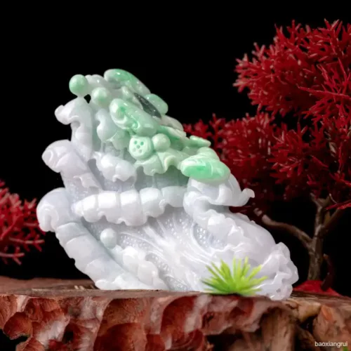 Carved jade sculpture with red coral background