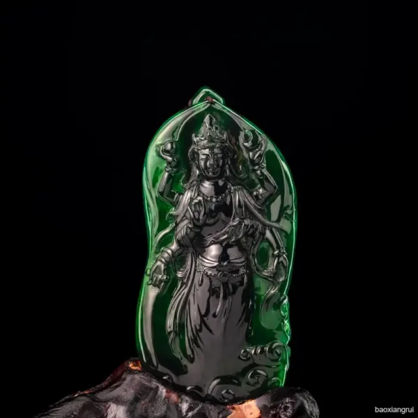 Carved jade sculpture of a deity on black background.