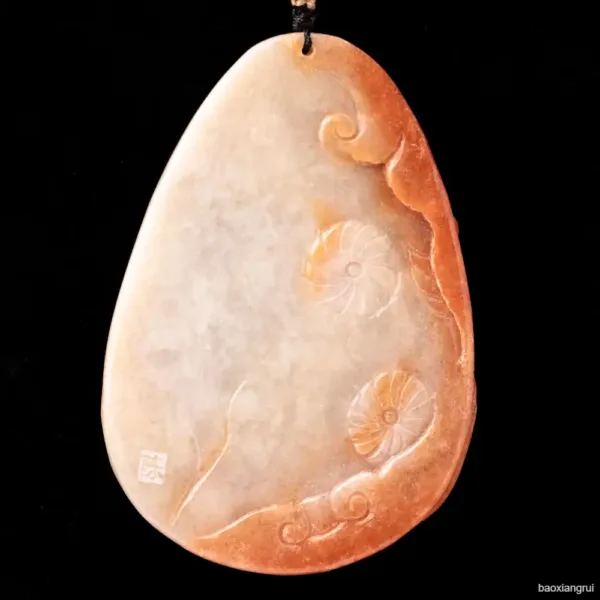 Carved jade pendant with ammonite fossils design.