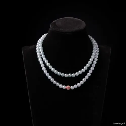 Double-strand pearl necklace on black display.