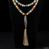 Colorful beaded necklace with tassel pendant on black.