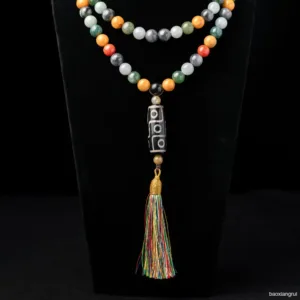 Colorful beaded necklace with tassel pendant on black.