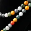 Colorful gemstone beads on black background.