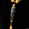 Ethnic patterned bead necklace against dark background.