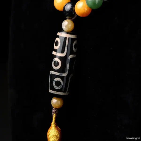 Ethnic patterned bead necklace against dark background.