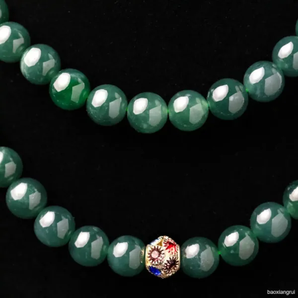 Green jadeite beads with ornate gold clasp.