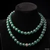 Double strand jade necklace with gemstone clasp on display.