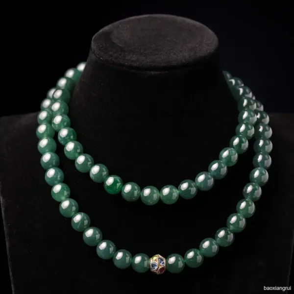 Double strand jade necklace with gemstone clasp on display.