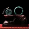 Antique jade sculptures on dark background