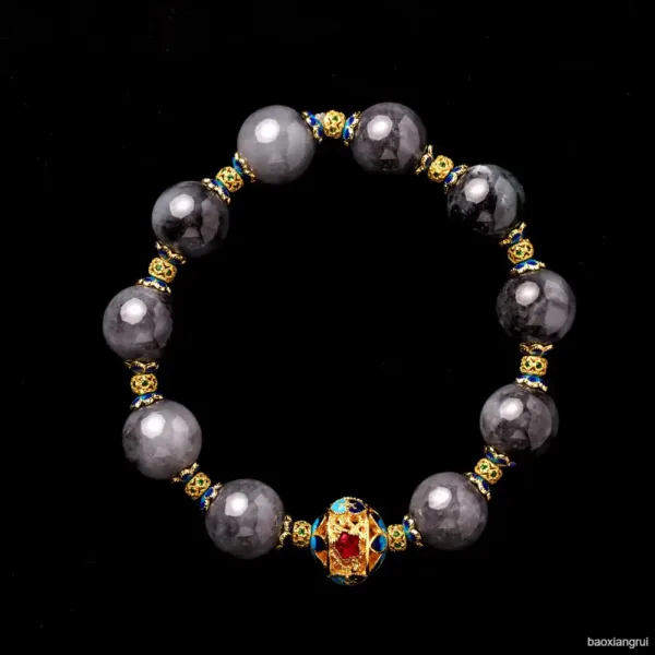 Elegant beaded bracelet with gold and gemstone accents.