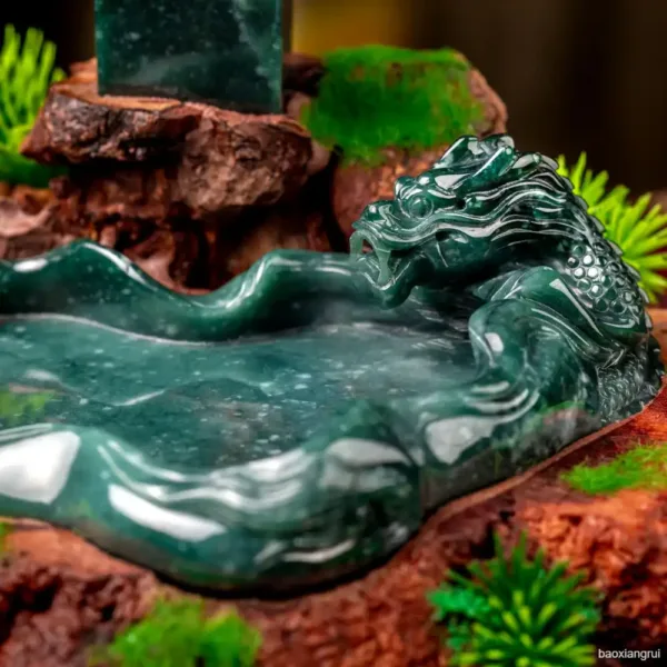 Carved jade dragon sculpture on wooden base.