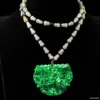 Jade pendant on beaded necklace against black background.