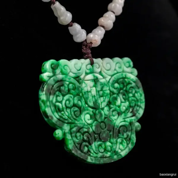 Carved jade pendant with white beaded necklace.