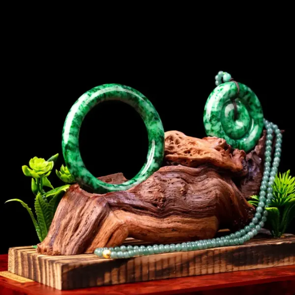 Jade jewelry display with wood and greenery.