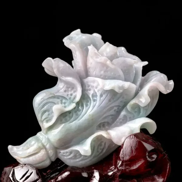 Carved jade flower sculpture on dark background