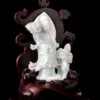 Jade Guanyin statue on wooden base