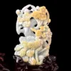 Carved jade floral sculpture on black background.