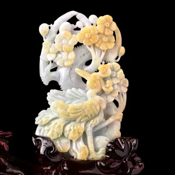 Carved jade floral sculpture on black background.