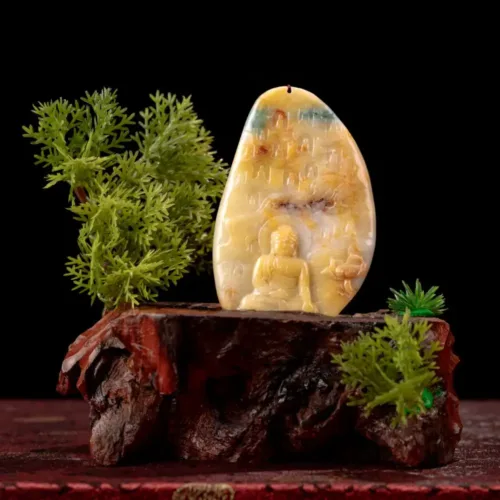 Carved Buddha in amber, wooden stand, greenery, black background.