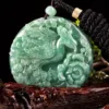 Carved jade pendant with black cord necklace.