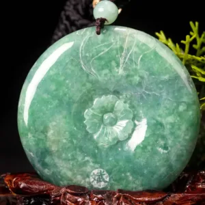 Carved jade pendant with floral design.